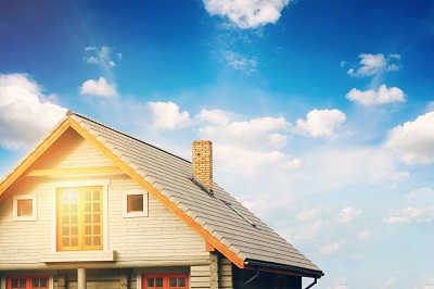 log lodge with gray tile roof against blue sky