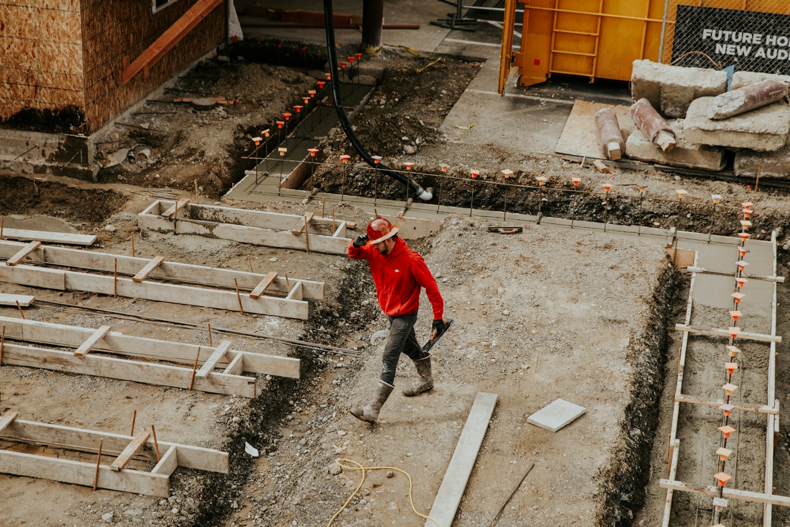 man in red jacket and black pants walking on gray concrete stairs, contractors insurance