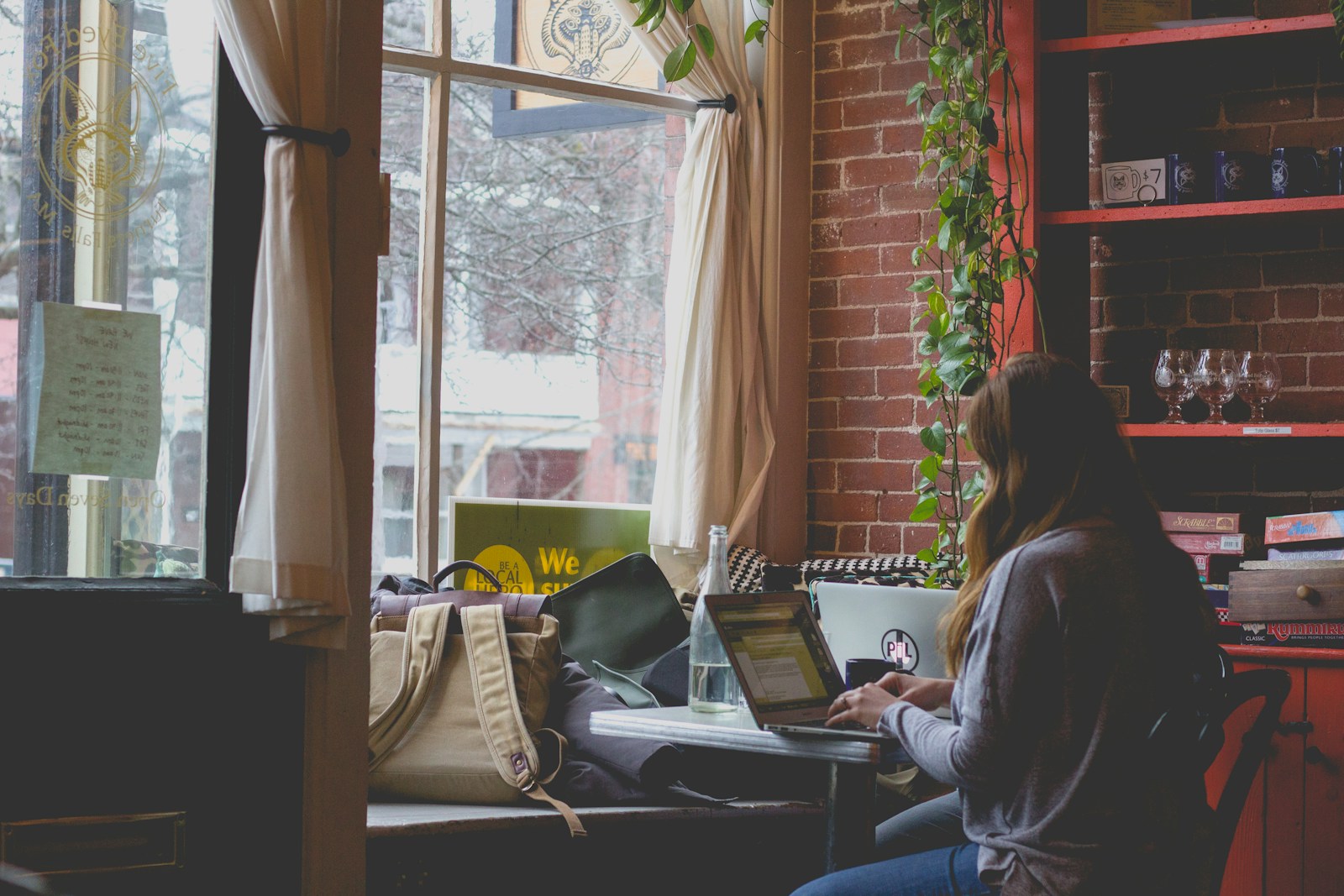 woman using computer sitting on black chair, renters