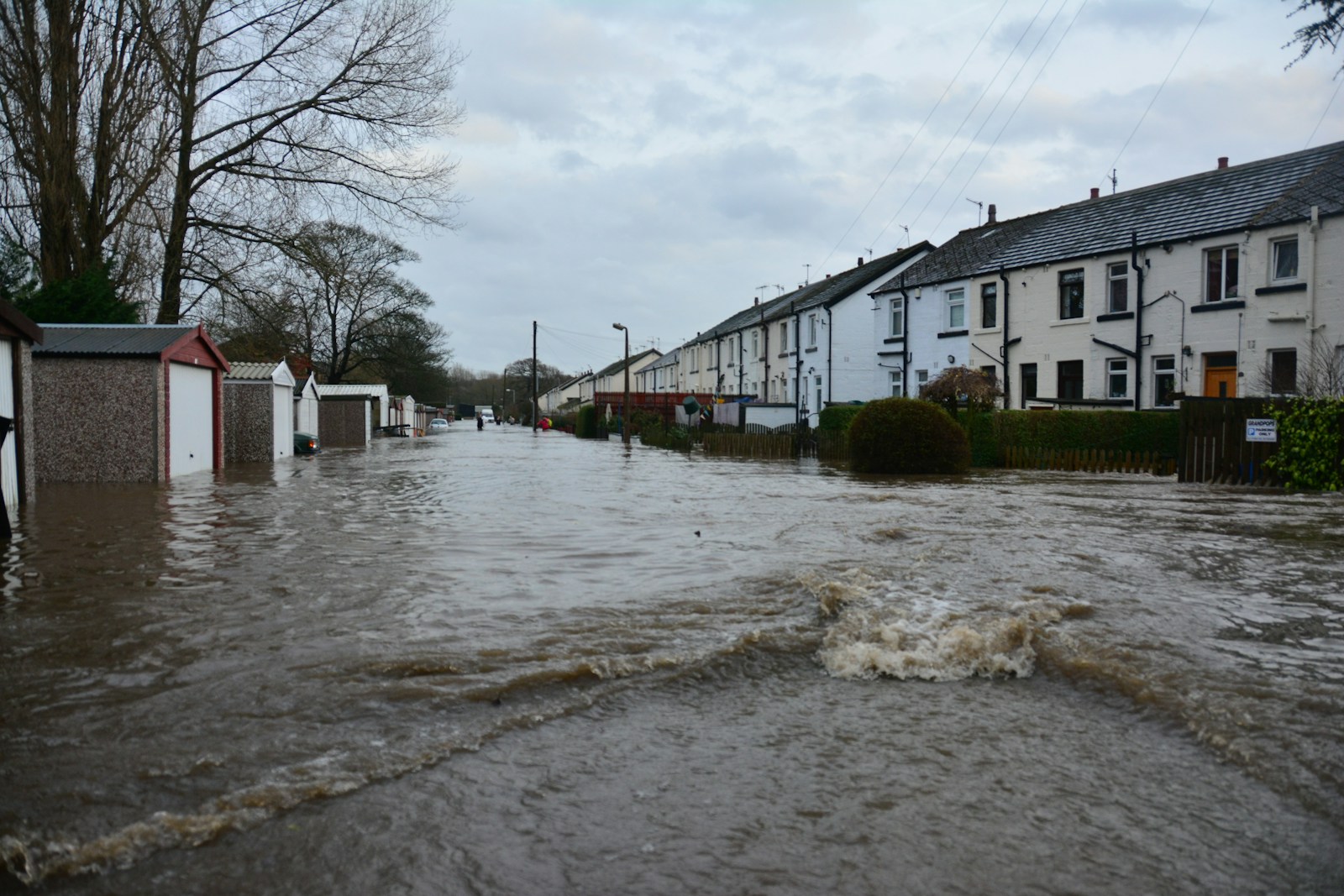 white and brown concrete building near body of water during daytime, flood